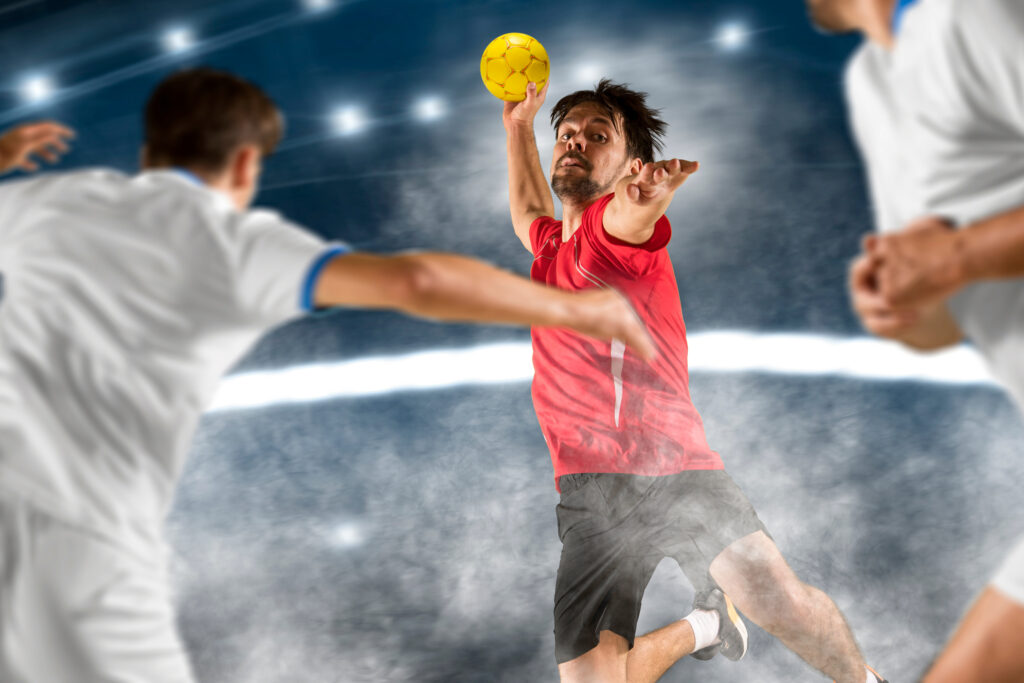 Caucasian young handball player in action. Concept of sport, movement, energy, dynamic, healthy lifestyle